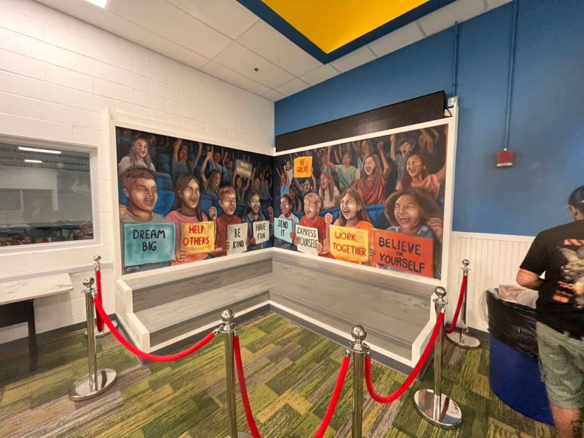 Boys & Girls Club mural of kids holding signs that say Dream Big and Believe in Yourself