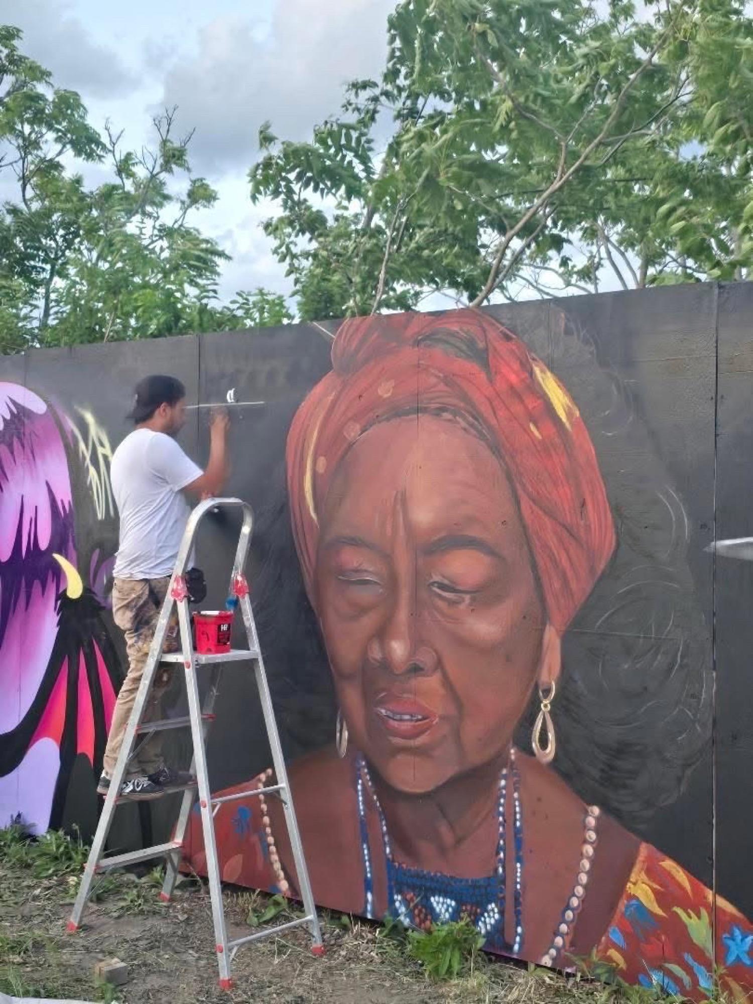 Portrait mural of Colombian singer Totó la Momposina in a red headwrap