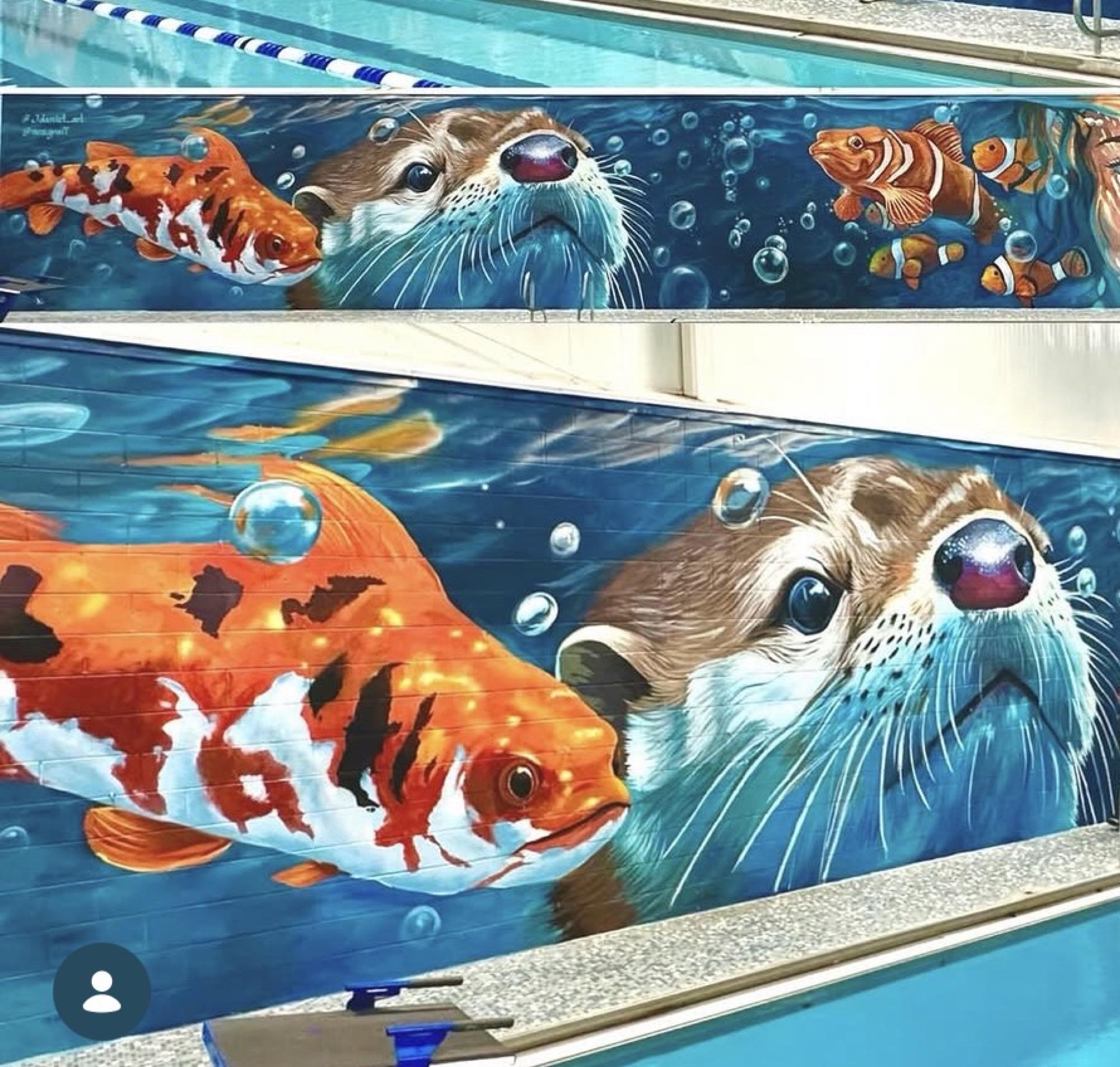 Aquatic center mural with an otter and koi fish among bubbles
