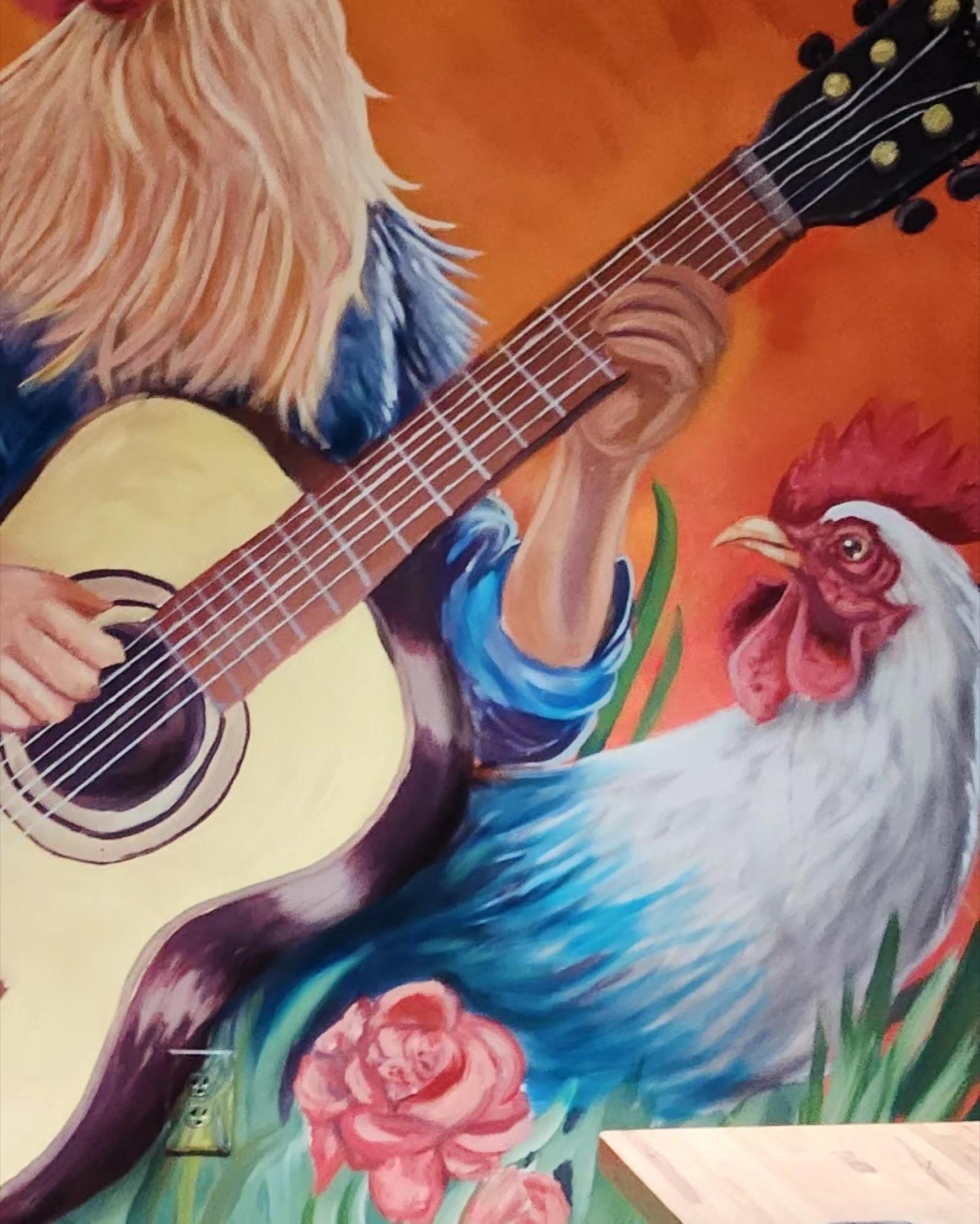 Restaurant mural of a guitar player and a rooster on a warm orange background
